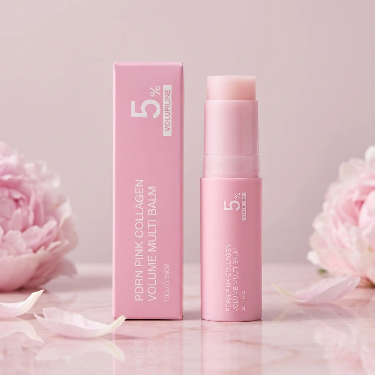 Gloreli PDRN Pink Collagen Multi Balm Stick and its pink box on pale pink marble with peonies