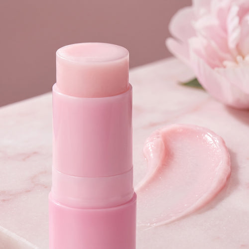 Close-up of the Gloreli PDRN Pink Collagen Multi Balm Stick with a creamy pink balm swipe on marble